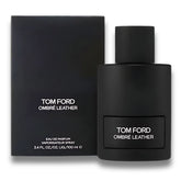 Frasco y estuche de Tom Ford Ombre Leather Eau de Parfum 100 ml – El frasco negro con detalles minimalistas se presenta junto a un estuche igualmente elegante y sobrio, resaltando el logotipo de Tom Ford. Esta combinación de lujo muestra la exclusividad del perfume